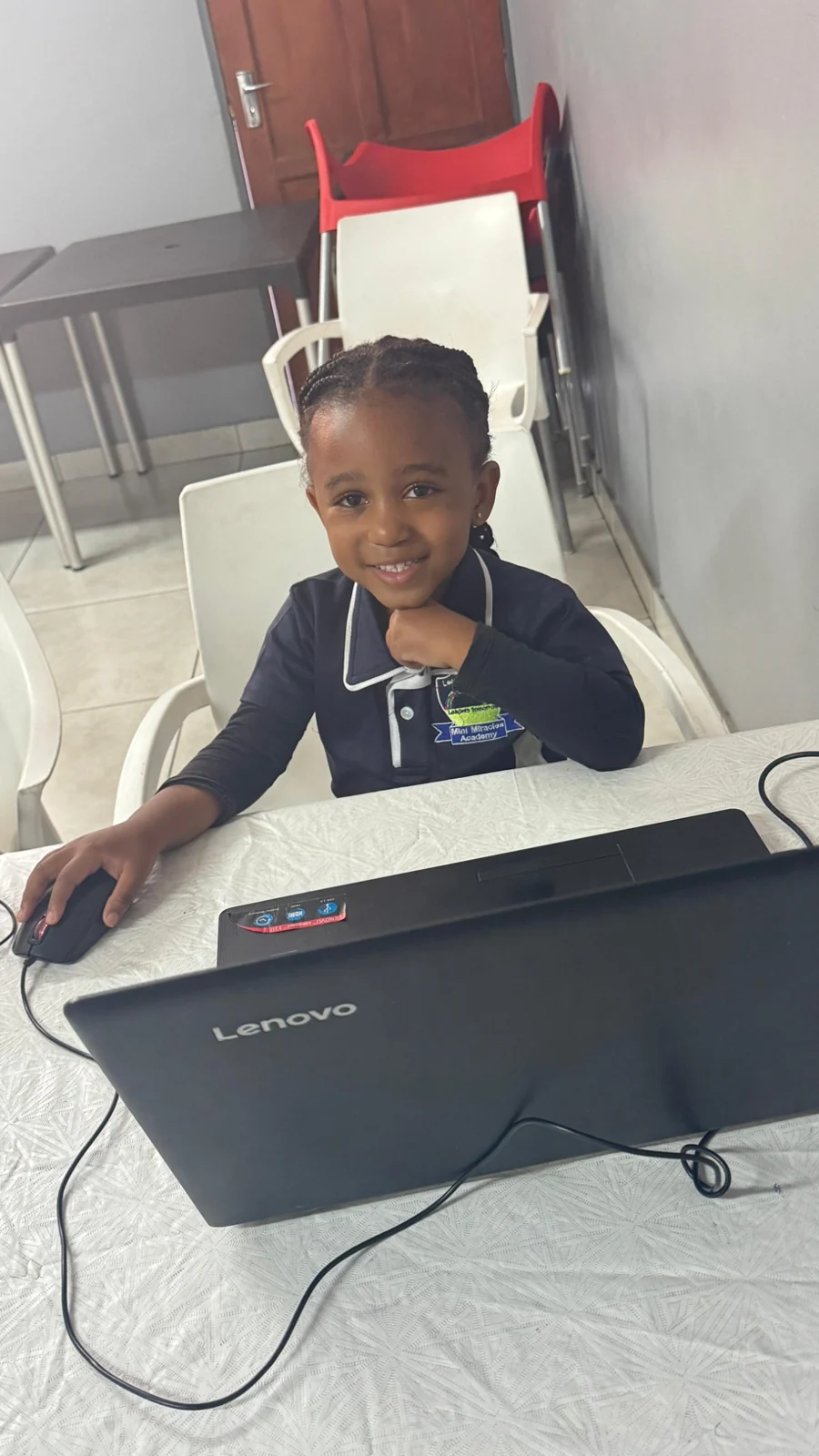 A learner smiling while using a computer