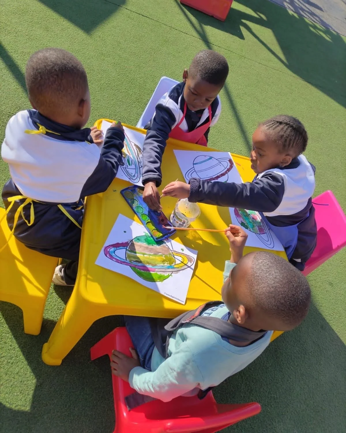 Young learners painting outdoors