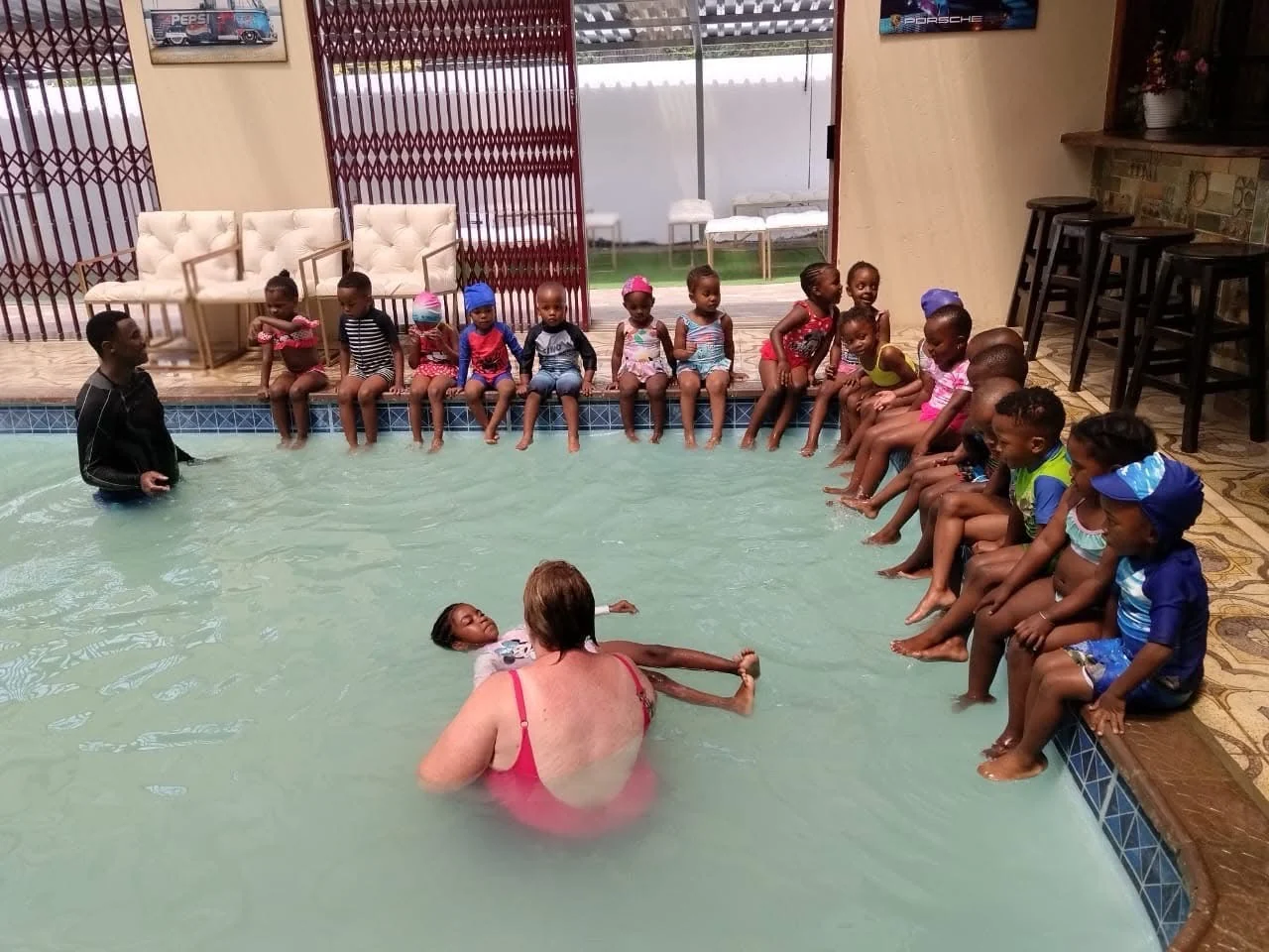 Children and adults taking part in a swimming session